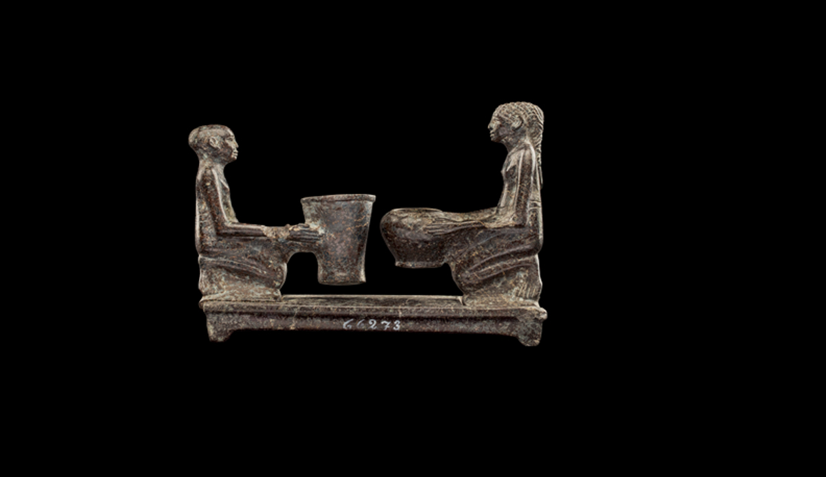 Two Figures Holding Cosmetic Vessels